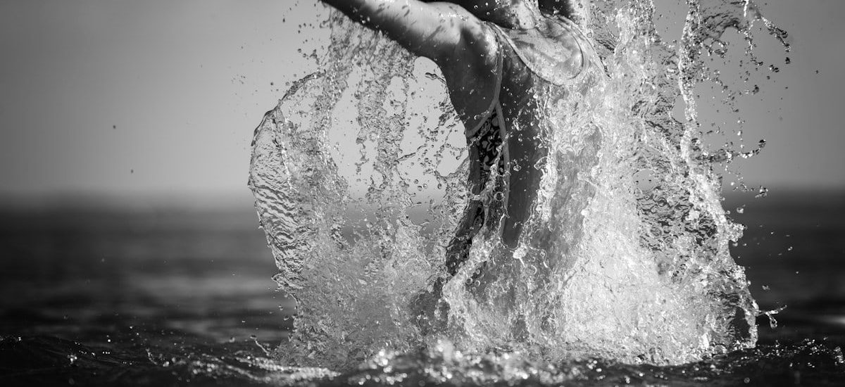 grayscale photo of woman in water
