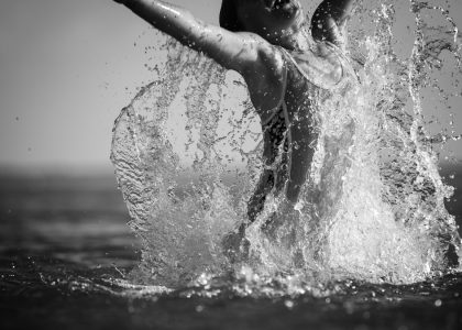 grayscale photo of woman in water